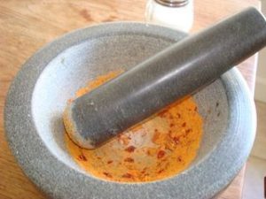 Grinding Raw Chile Pepper and Sea Salt