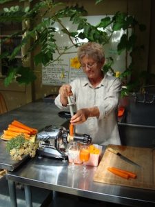 Paula Making Raw Juice in Greenhouse
