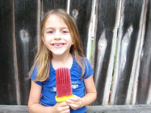 Young Girl With Raw Popsicle Snack